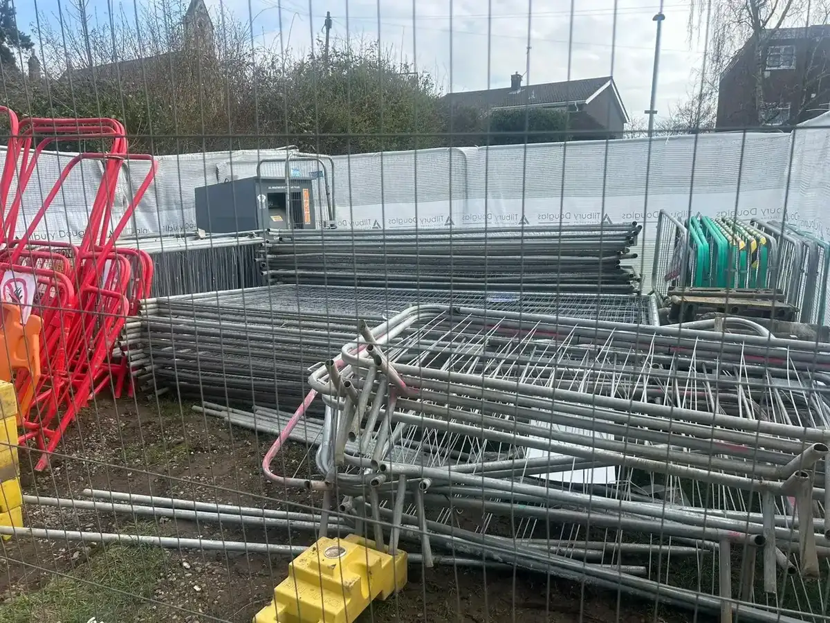 Stacked temporary fencing and barriers on a commercial site
