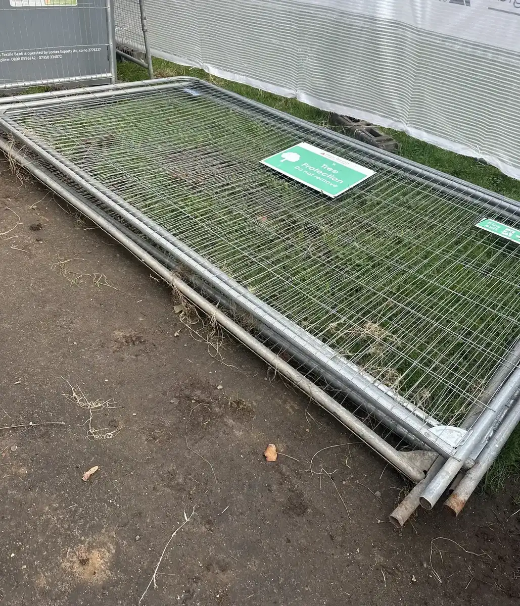 Temporary metal fencing panels awaiting collection