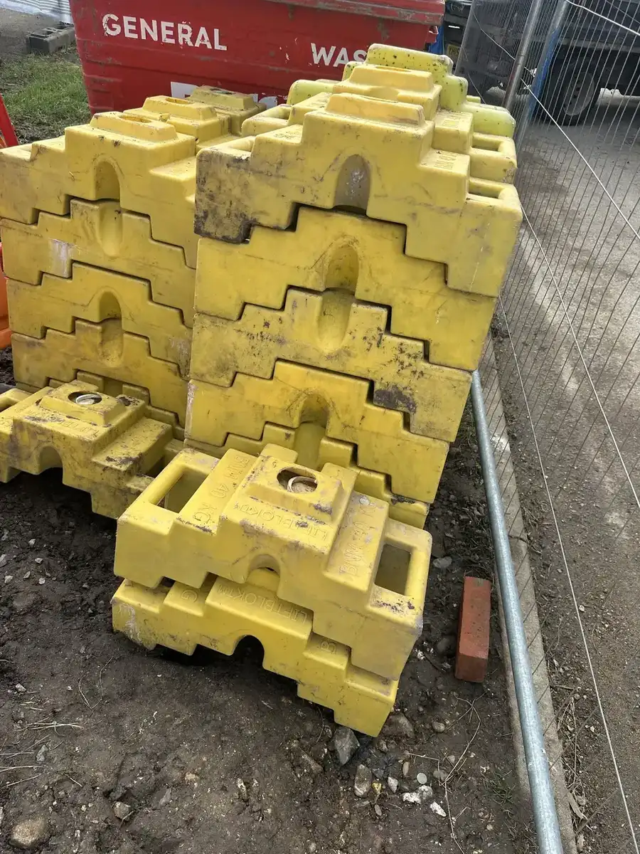 Stacked yellow temporary barrier bases