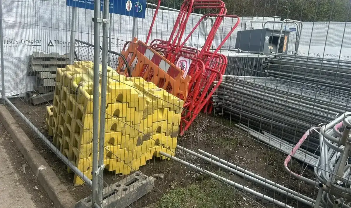 Temporary site barriers and weighted bases in storage area