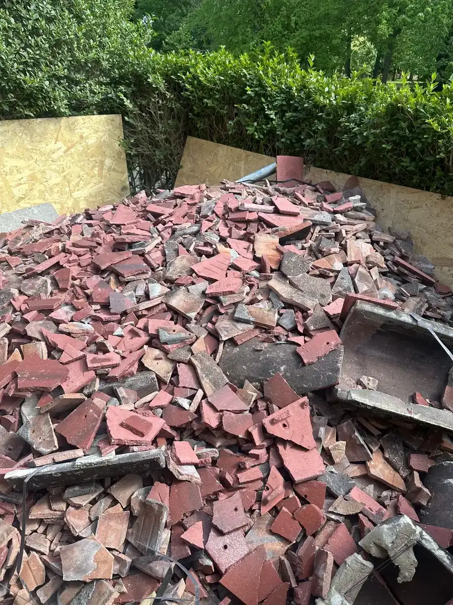 Large pile of broken roofing tiles and rubble