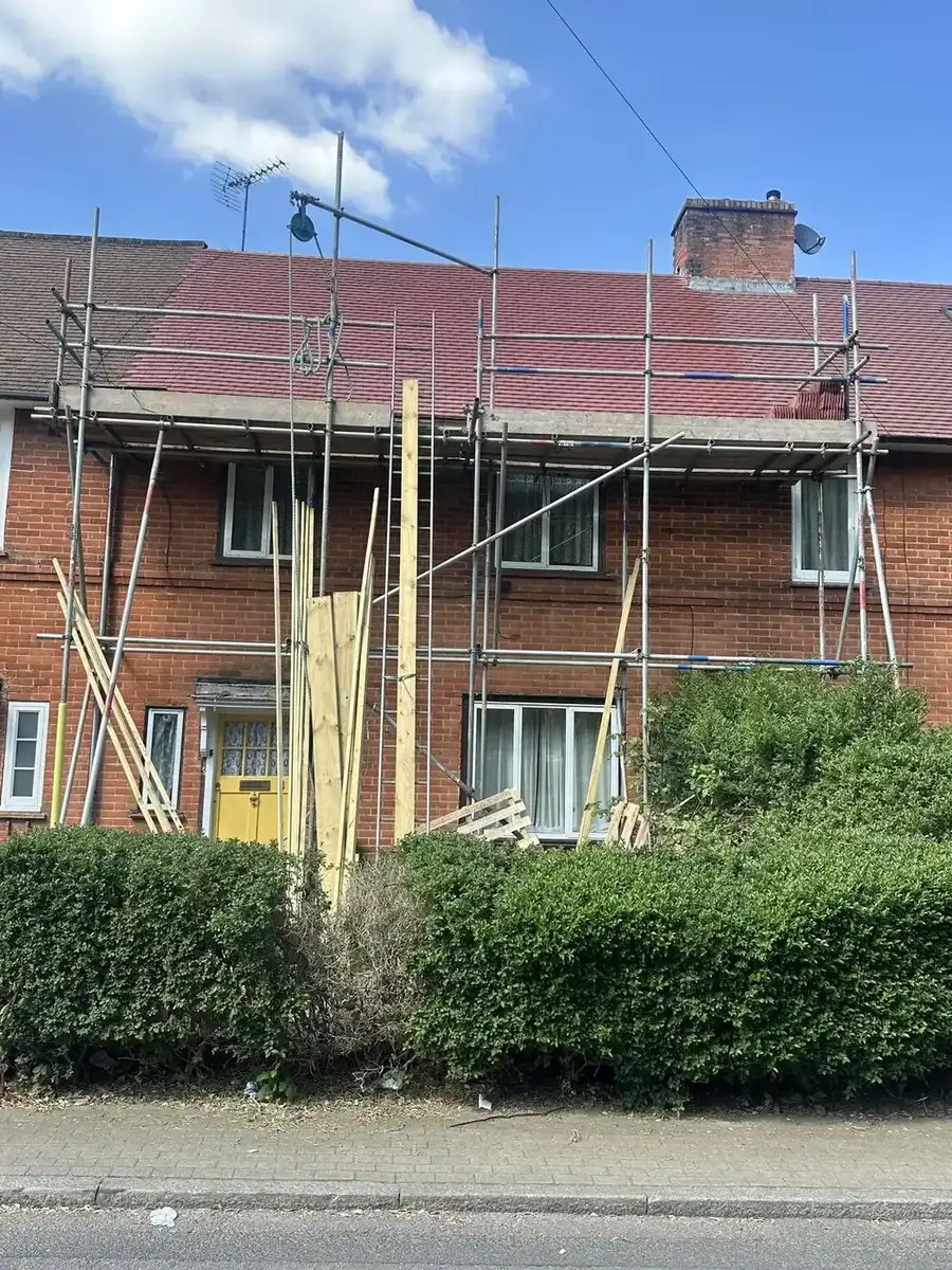 Scaffolded residential property for roofing waste clearance